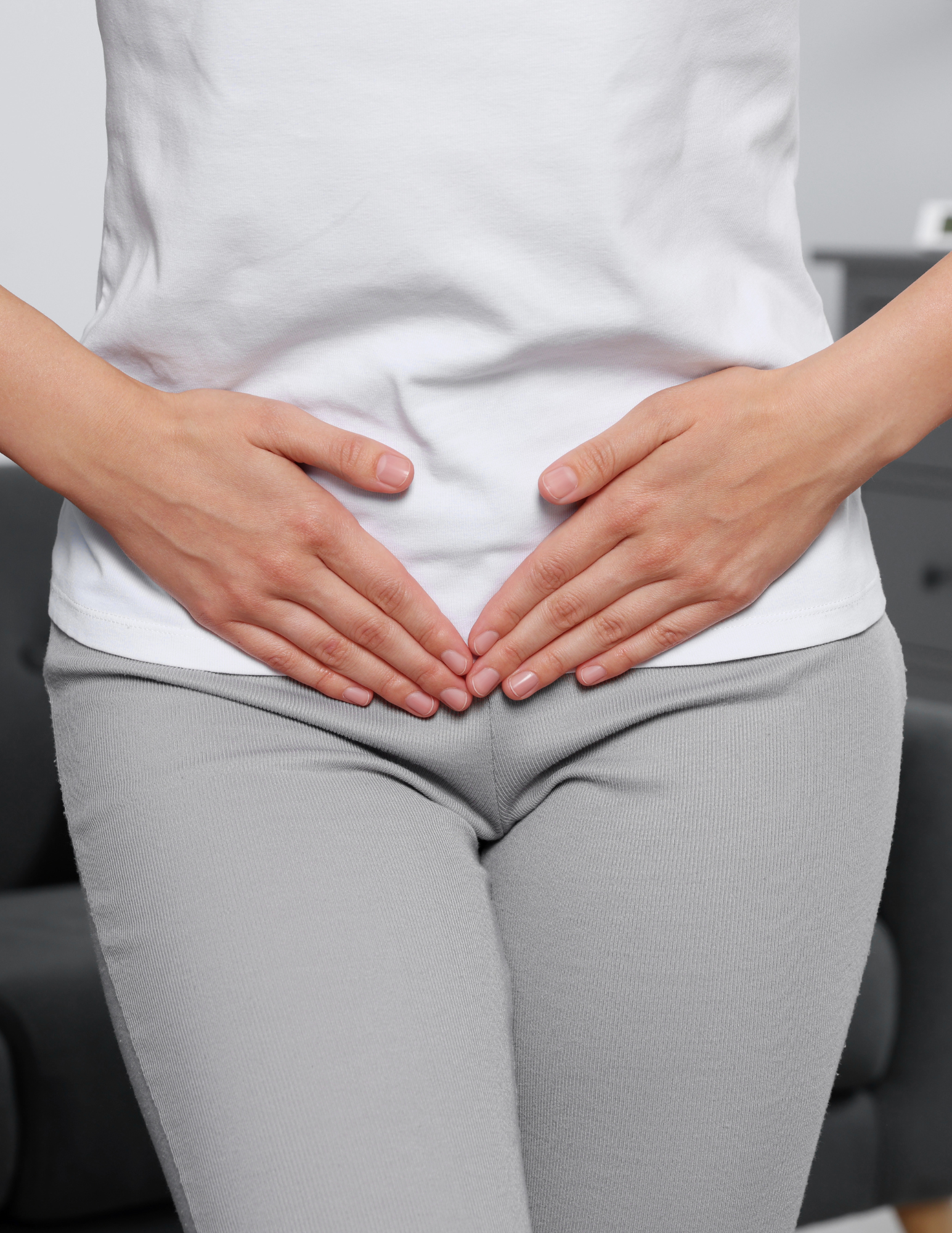 Dr Brouk Emsella chair Lady putting her hands on pelvic floor area